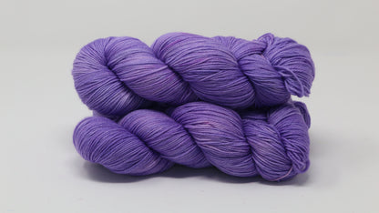 Stack of 3 purple skeins of yarn