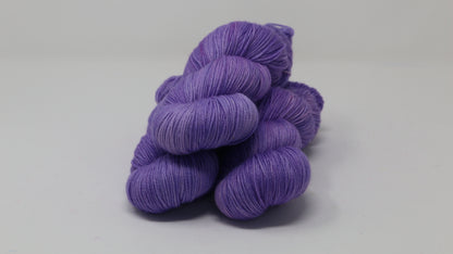 Stack of 3 purple skeins of yarn