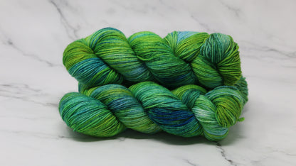 three skeins piled in tones of green and blue