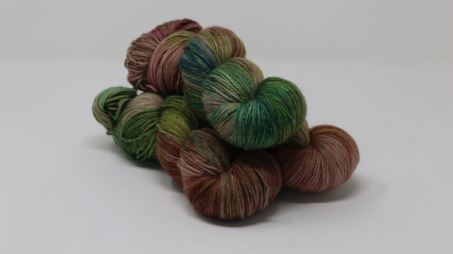 3 skeins of brown, green, blue yarn