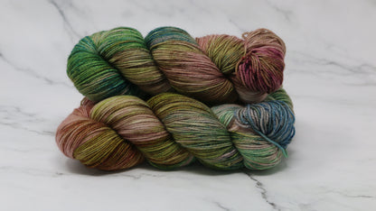 3 skeins of brown, green, blue yarn