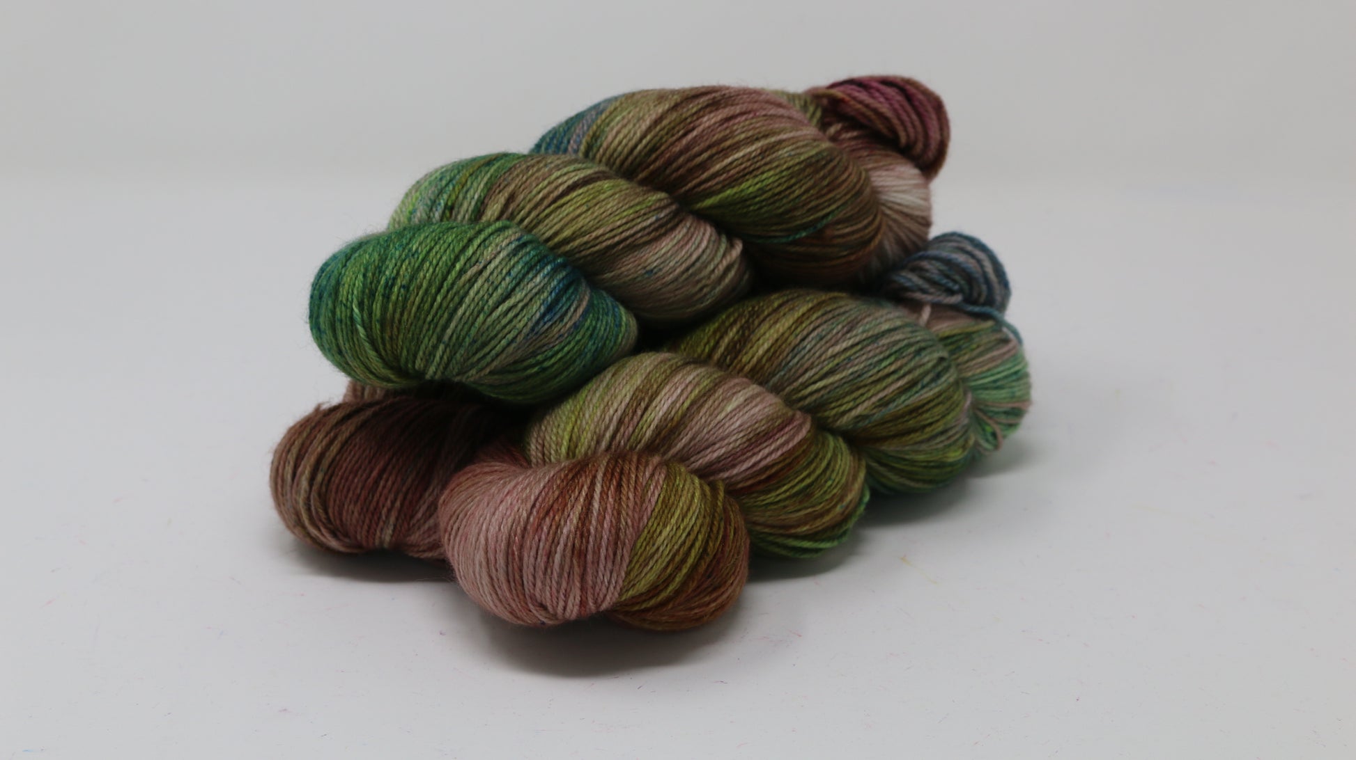 3 skeins of brown, green, blue yarn