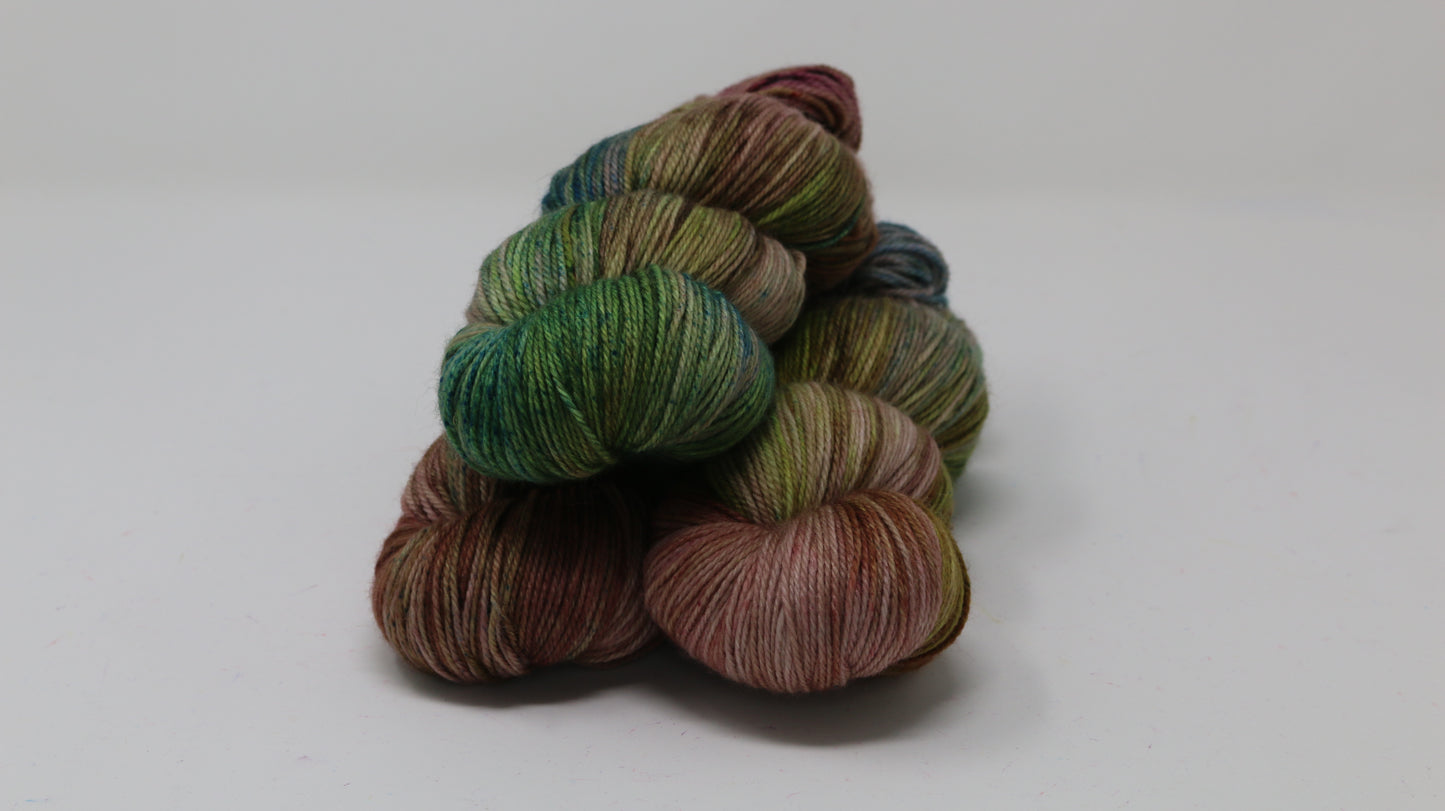 3 skeins of brown, green, blue yarn