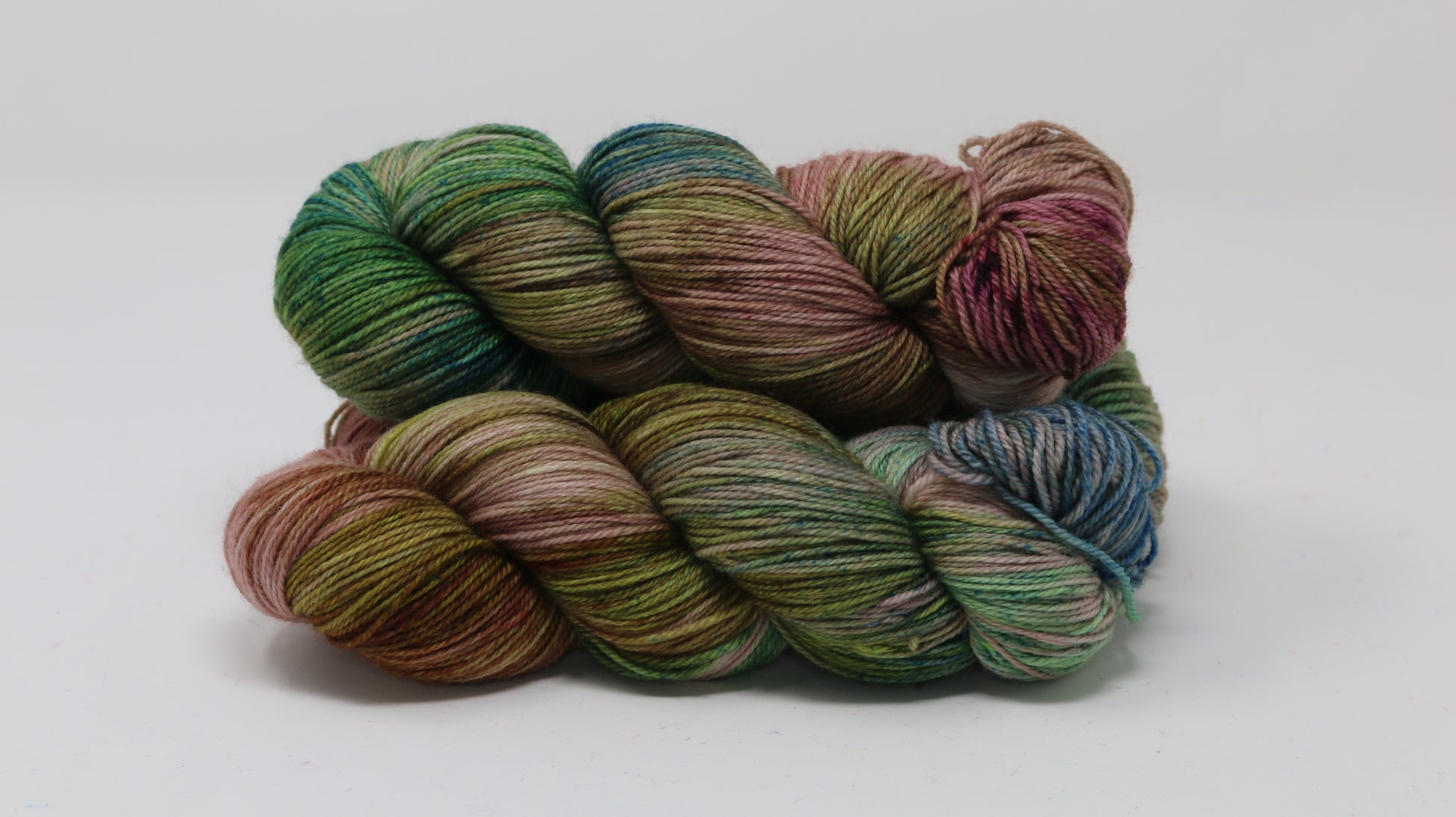 3 skeins of brown, green, blue yarn