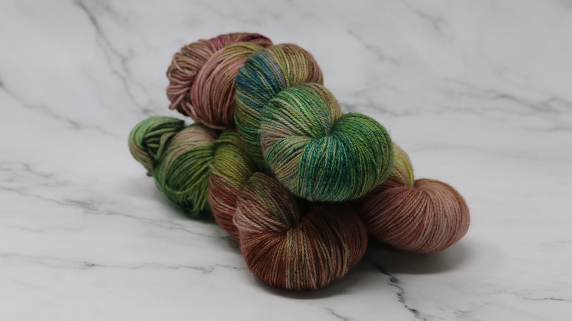 3 skeins of brown, green, blue yarn