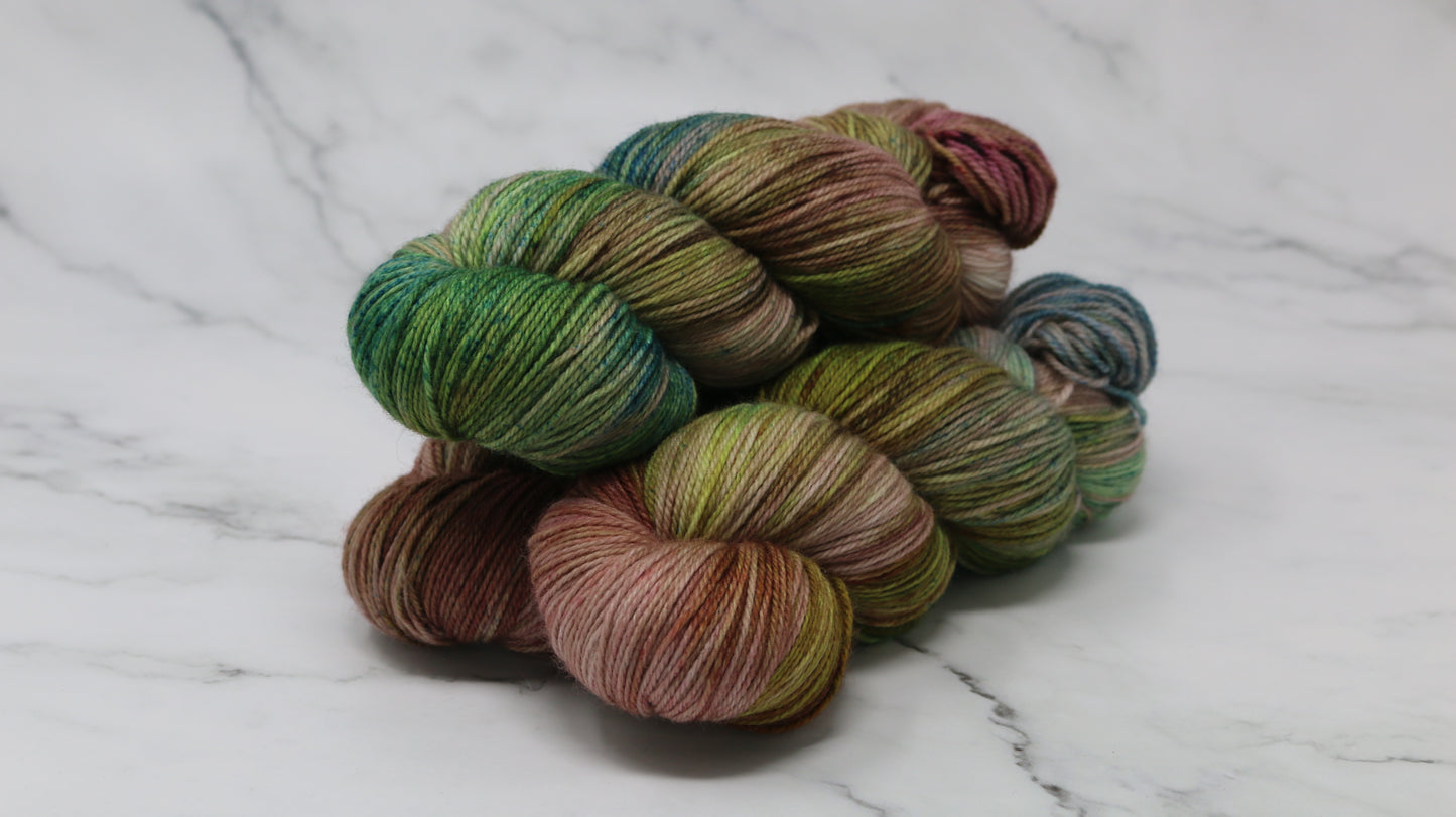 3 skeins of brown, green, blue yarn