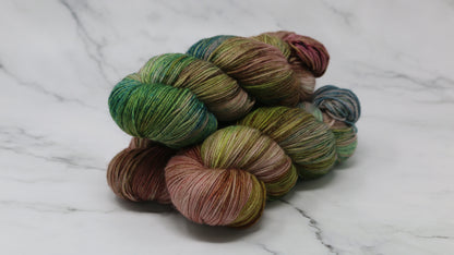 3 skeins of brown, green, blue yarn