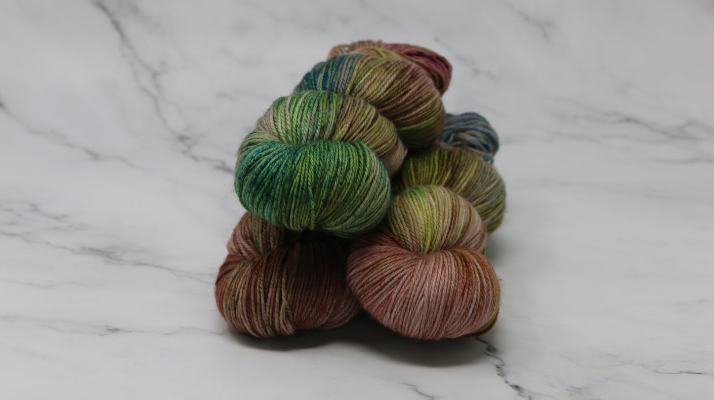3 skeins of brown, green, blue yarn
