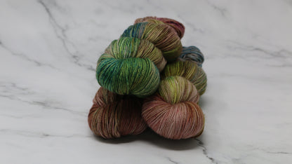 3 skeins of brown, green, blue yarn