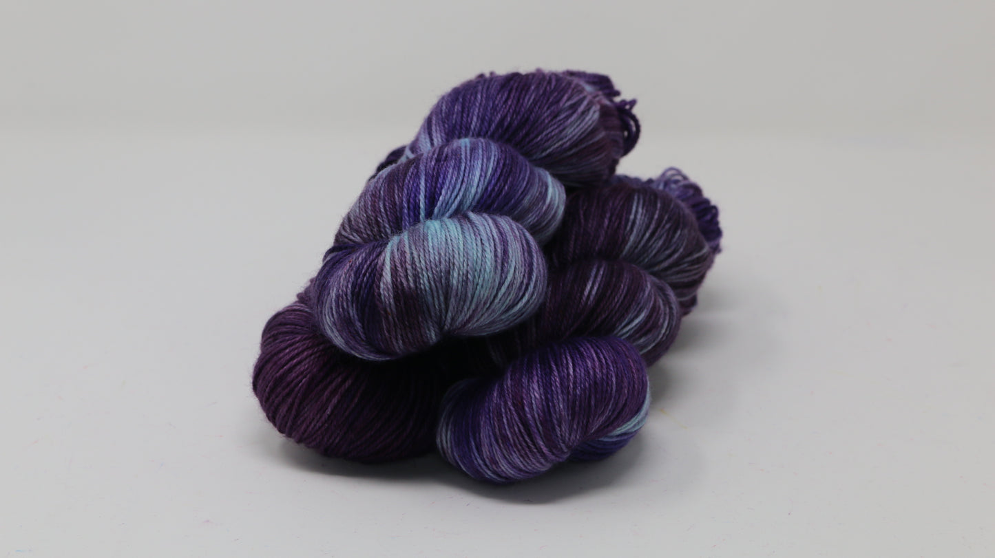 Three skeins of variegated purple and blue yarn