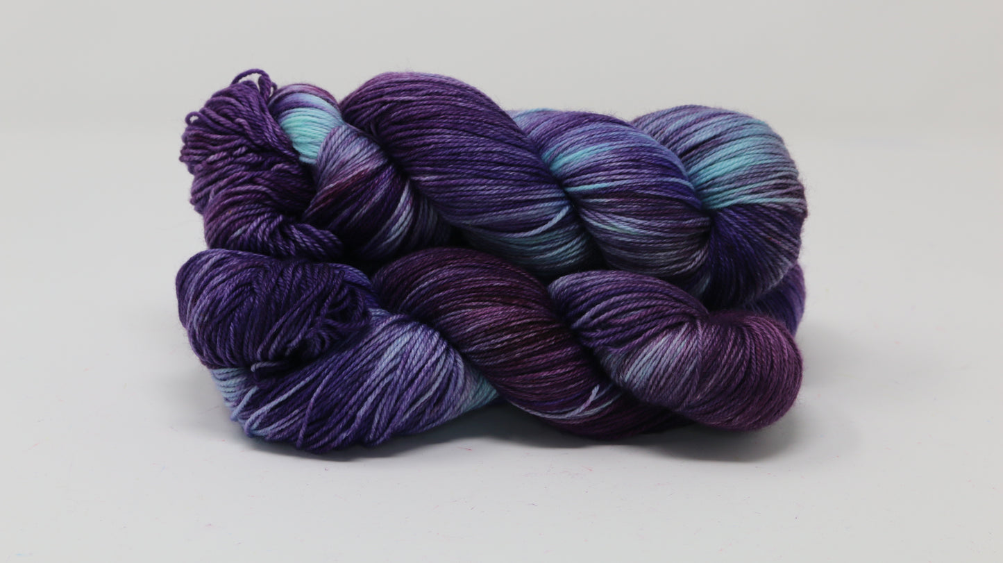 Three skeins of variegated purple and blue yarn
