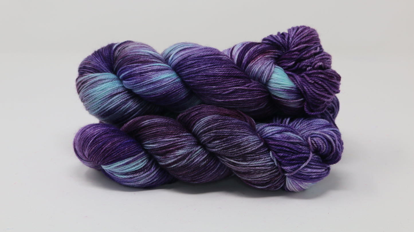 Three skeins of variegated purple and blue yarn