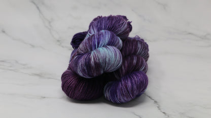 Three skeins of variegated purple and blue yarn