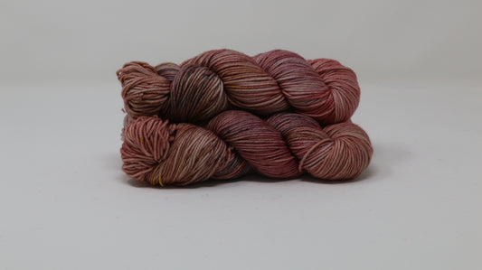 3 skeins of variegated yarn on a white surface and background