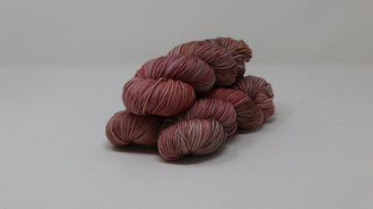 3 skeins of variegated yarn on a white surface and background