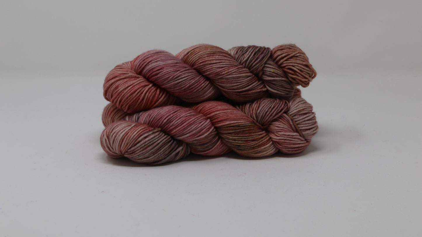 3 skeins of variegated yarn on a white surface and background