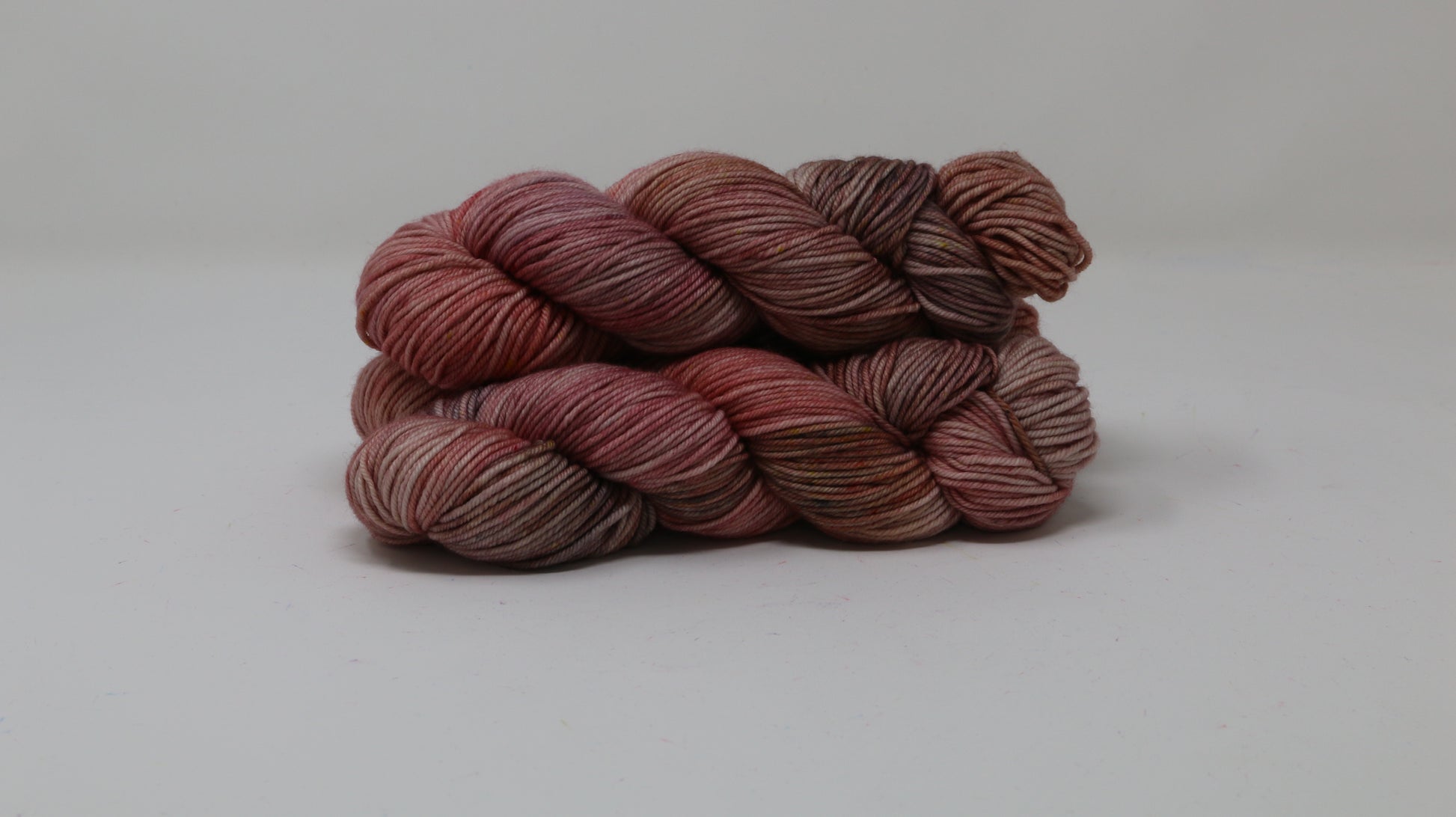 3 skeins of variegated yarn on a white surface and background