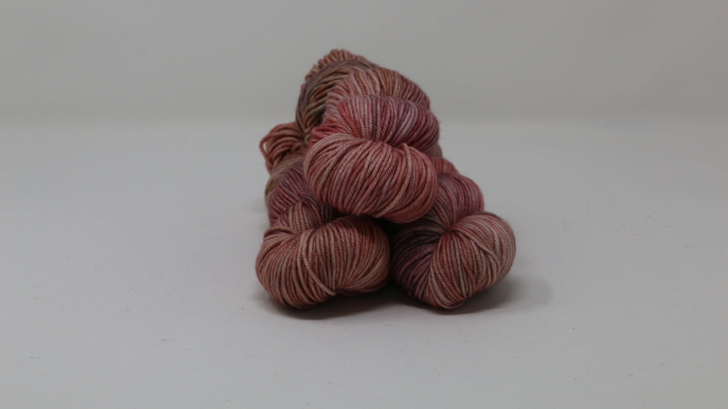 3 skeins of variegated yarn on a white surface and background