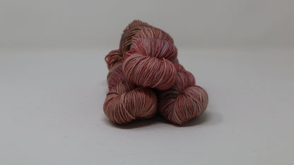 3 skeins of variegated yarn on a white surface and background