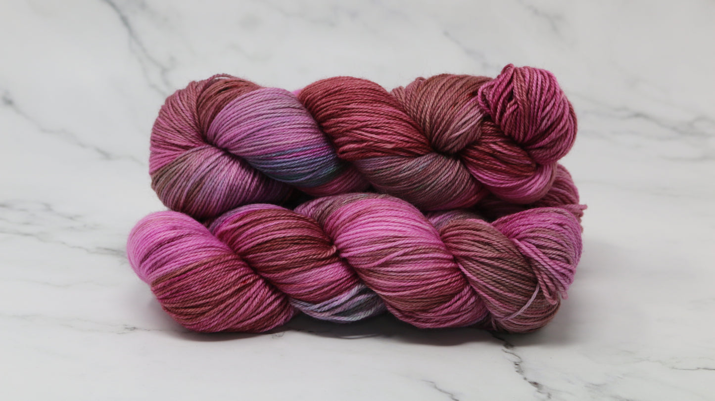 3 skeins of pink, red, green yarn