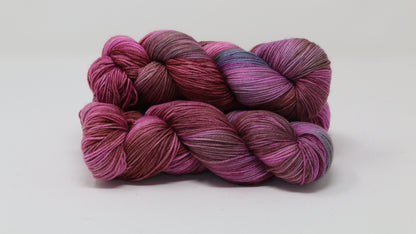 3 skeins of pink, red, green yarn