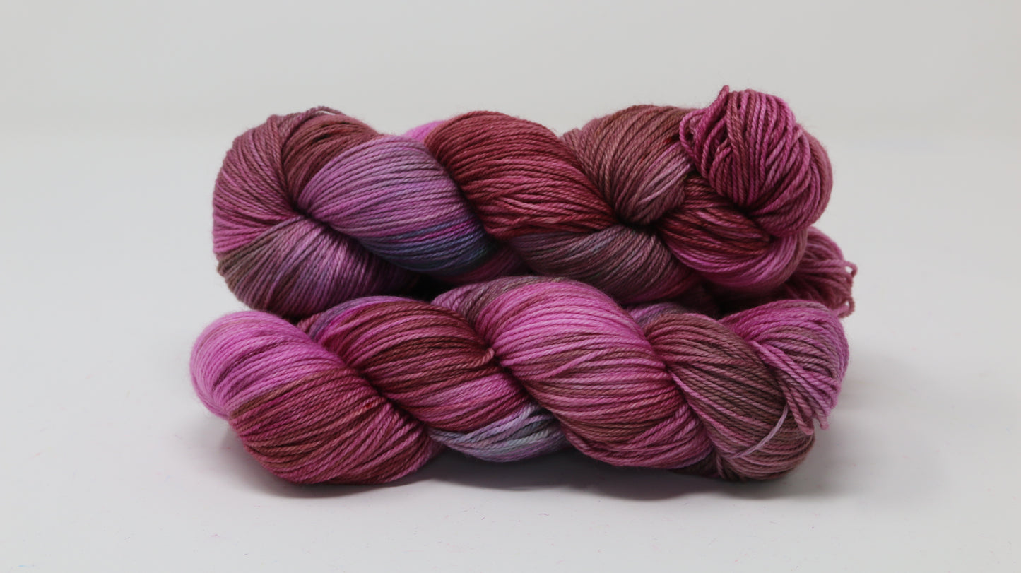 3 skeins of pink, red, green yarn