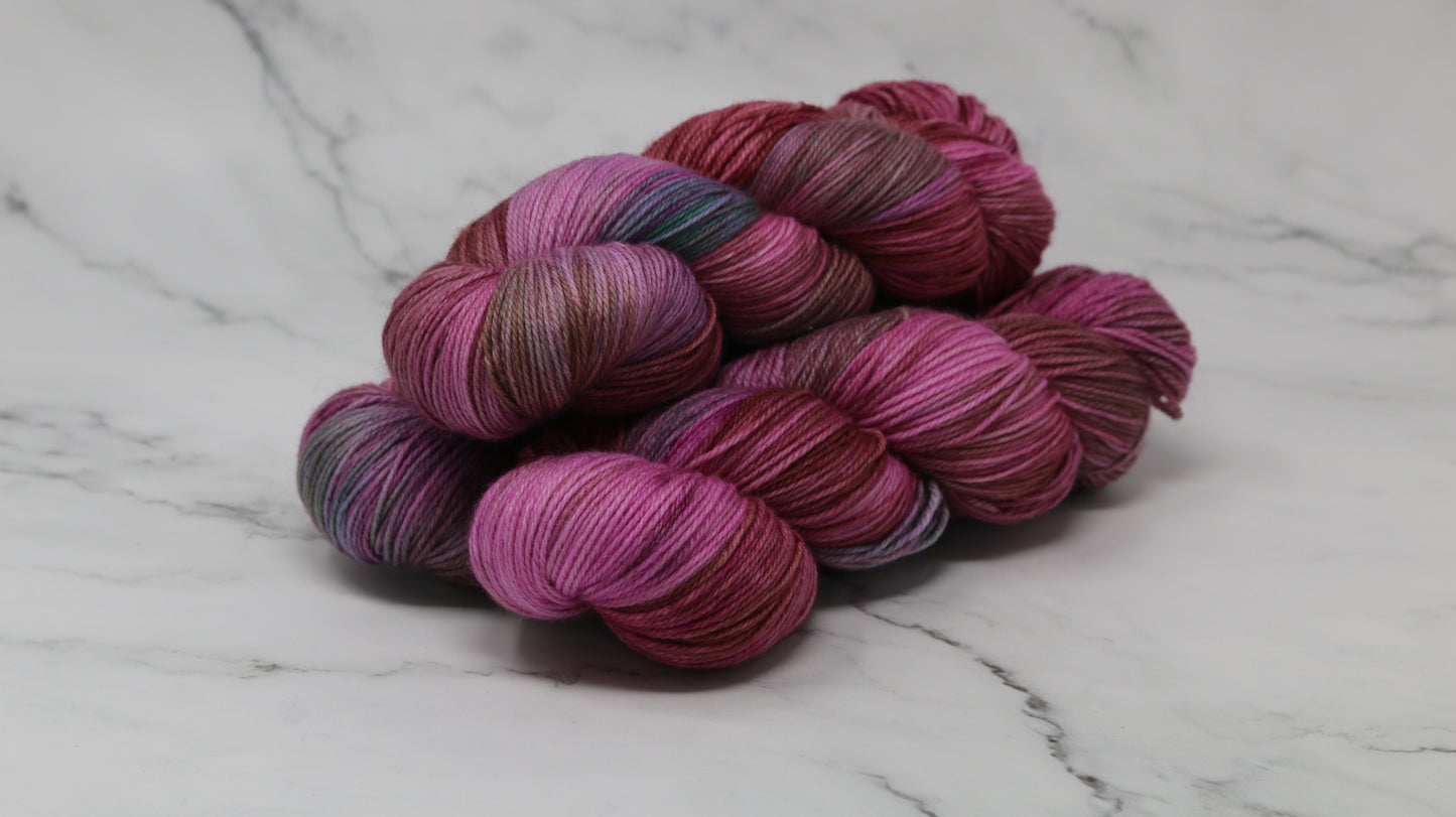 3 skeins of pink, red, green yarn