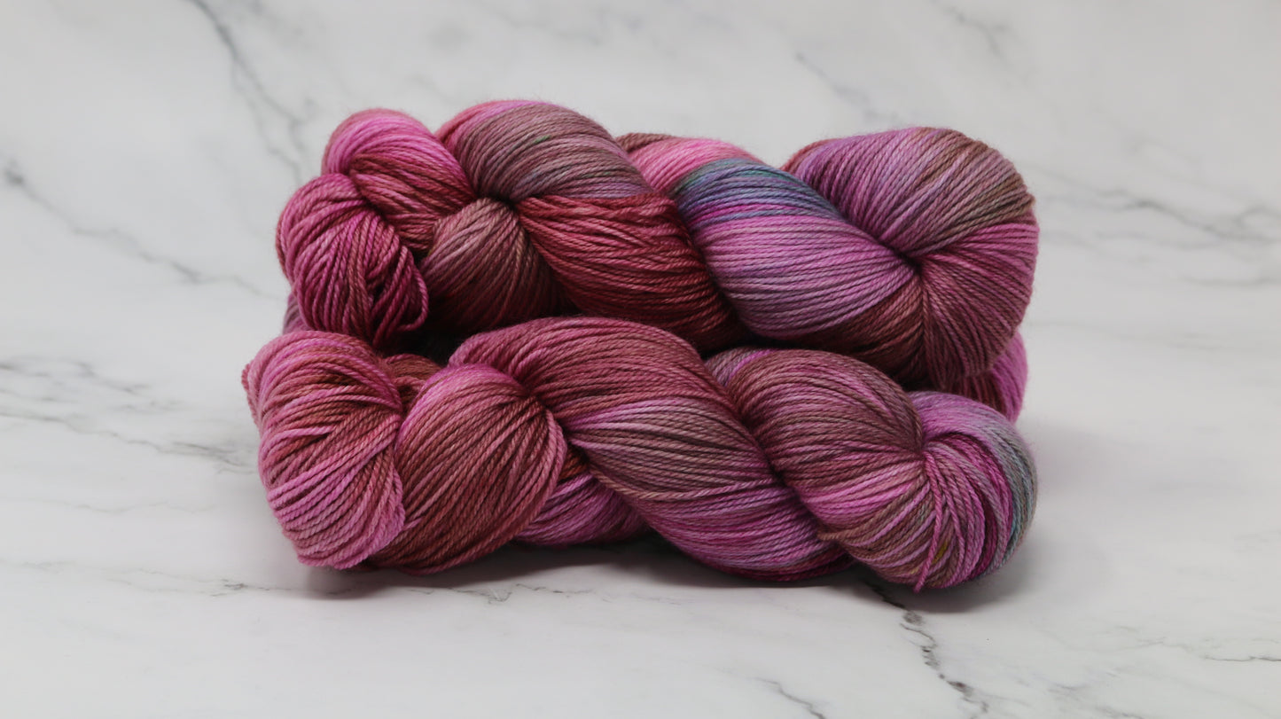 3 skeins of pink, red, green yarn