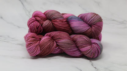 3 skeins of pink, red, green yarn